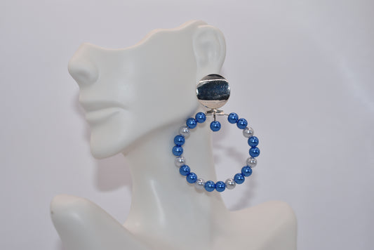 Calling all my ladies who love the color blue.&nbsp; These pretty light and dark blue pearls are sure to go with any outfit day or night.&nbsp; These hoops hang from a silver round surgical&nbsp;steel post. Hypoallergenic for sensitive ears.&nbsp; &nbsp;