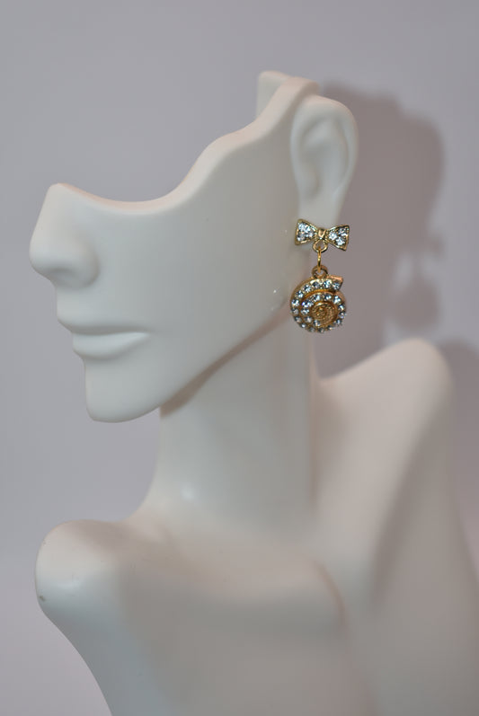 Make a stylish statement with our Nautical Collection 14 earrings! These adorable gold-plated hypoallergenic crystal bow posts hold a seashell gold crystal charm, adding the perfect touch to your summertime outfits. Fun, classy, and oh-so chic, these earrings are a must-have for any fashion-forward individual.