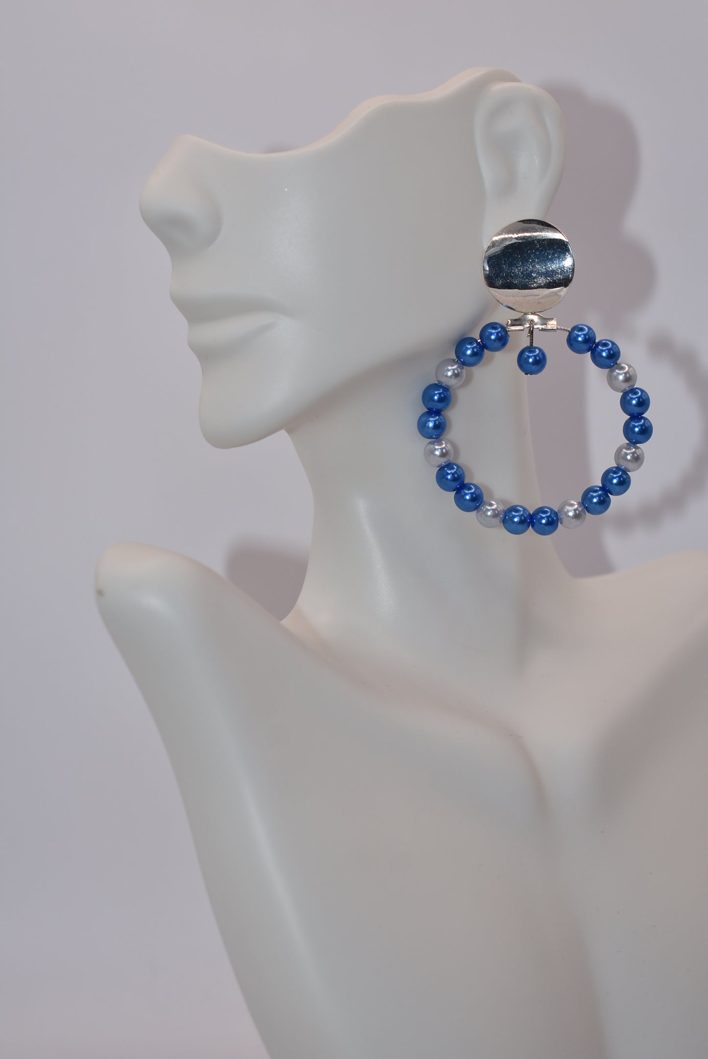 Calling all my ladies who love the color blue.&nbsp; These pretty light and dark blue pearls are sure to go with any outfit day or night.&nbsp; These hoops hang from a silver round surgical&nbsp;steel post. Hypoallergenic for sensitive ears.&nbsp; &nbsp;