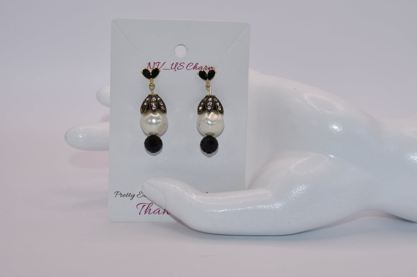 These Beautiful Black crystal and gold posts will charm you! The big pearl, crowned with crystals, is accentuated with a pretty black bead at the bottom. Whether you dress up or down, these earrings will win your heart!