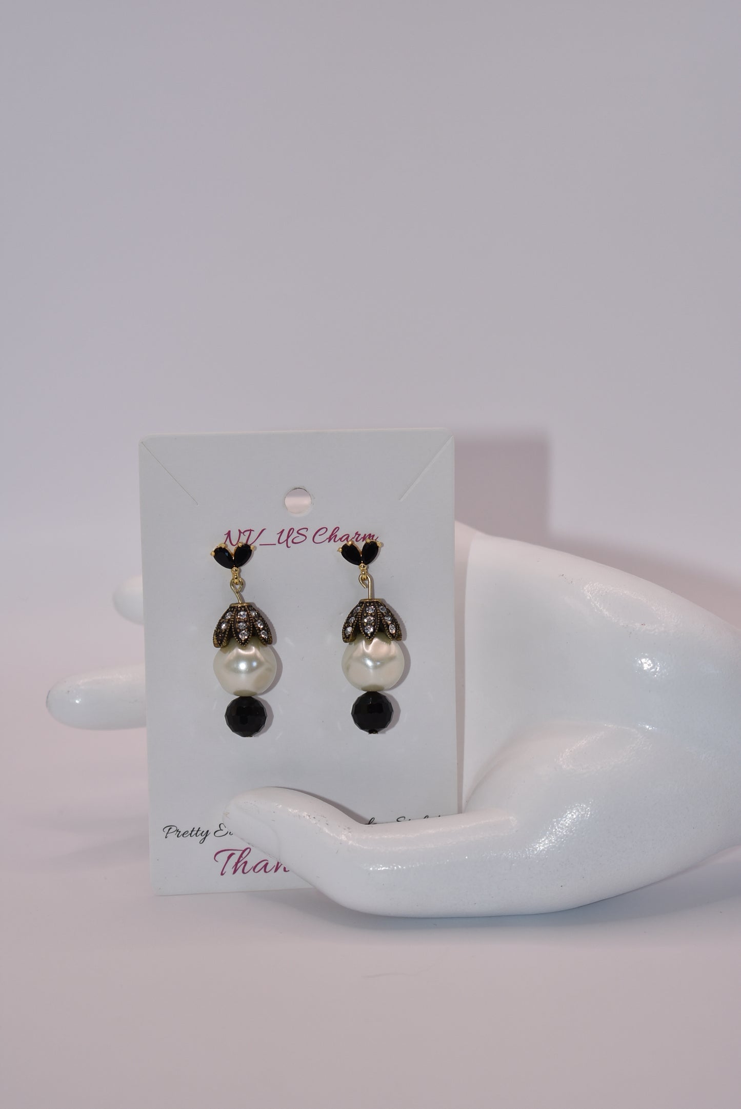 These Beautiful Black crystal and gold posts will charm you! The big pearl, crowned with crystals, is accentuated with a pretty black bead at the bottom. Whether you dress up or down, these earrings will win your heart!