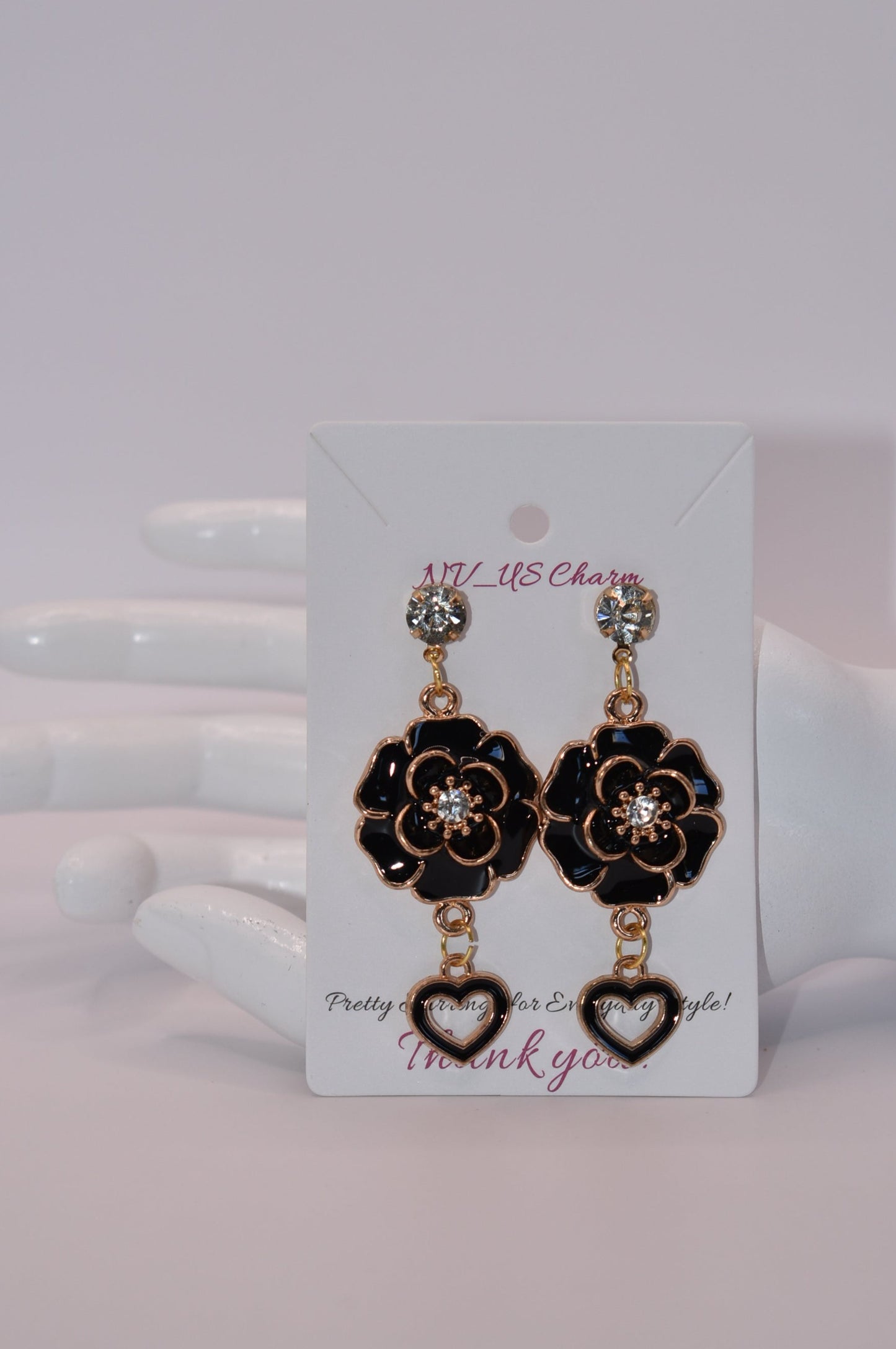 These black beauties are diamond posts with black flowers with middle crystal and have a hanging black open heart on the bottom.&nbsp; They are on the heavier side. Gorgeous on the ear.&nbsp;&nbsp;One-of-a-kind piece.