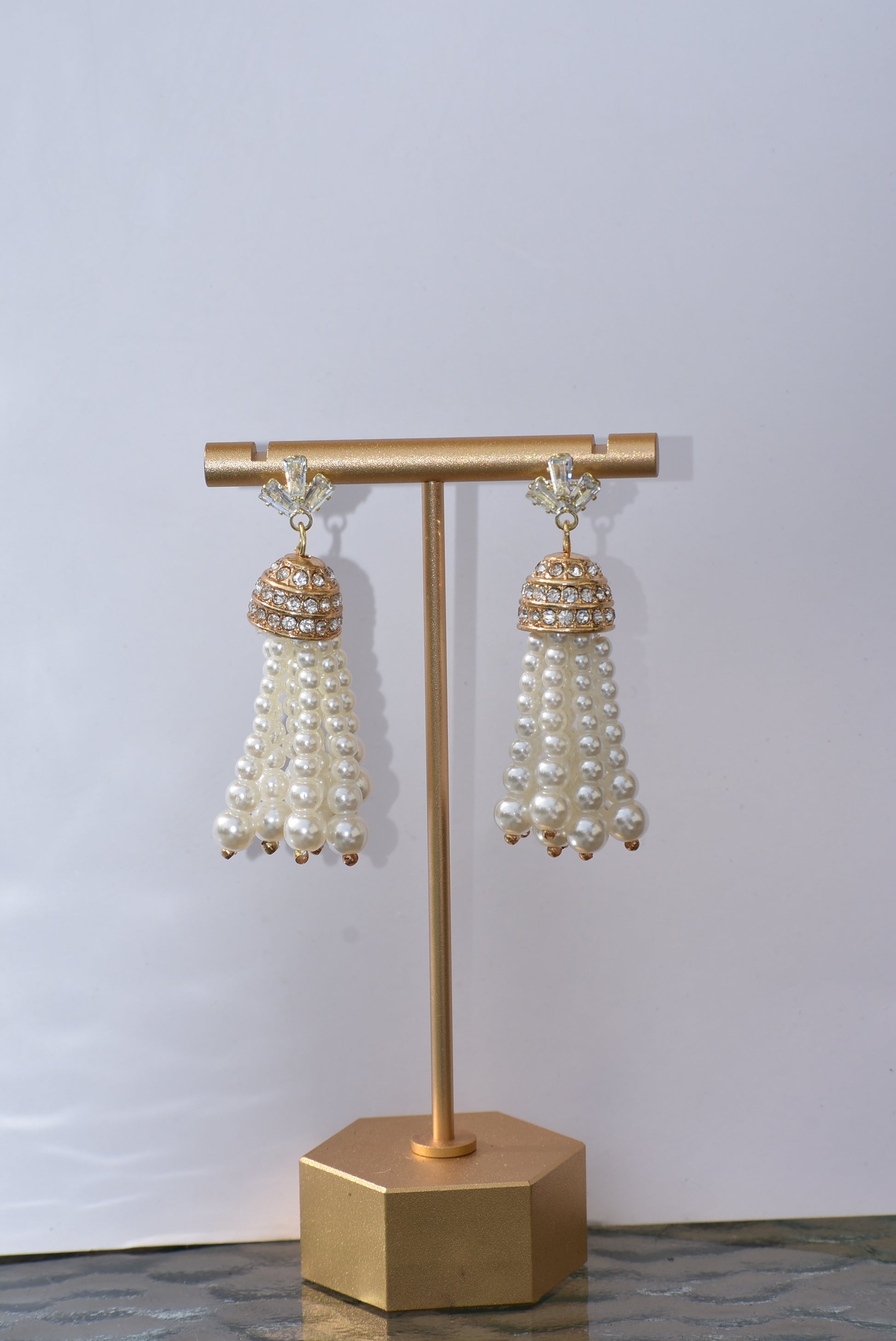 Our Wedding Collection is a beautiful and luxurious addition to any special occasion. Crafted with quality cubic zirconia studs and a dome crystal piece, these earrings are complemented by a delicate pearl strands. These earrings are hypoallergenic and perfect for any wedding.