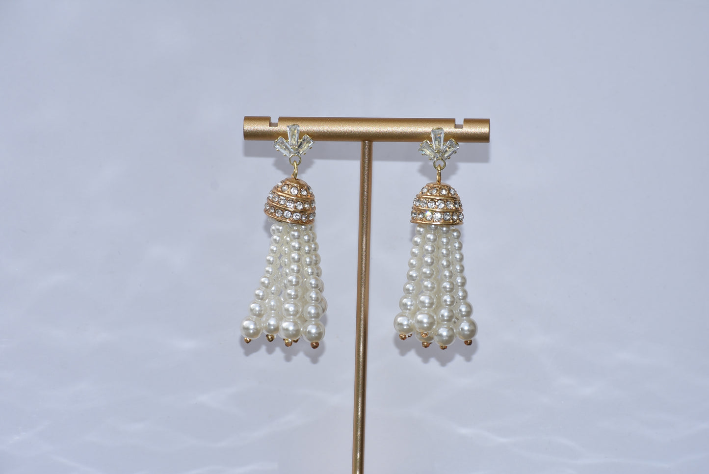 Our Wedding Collection is a beautiful and luxurious addition to any special occasion. Crafted with quality cubic zirconia studs and a dome crystal piece, these earrings are complemented by a delicate pearl strands. These earrings are hypoallergenic and perfect for any wedding.