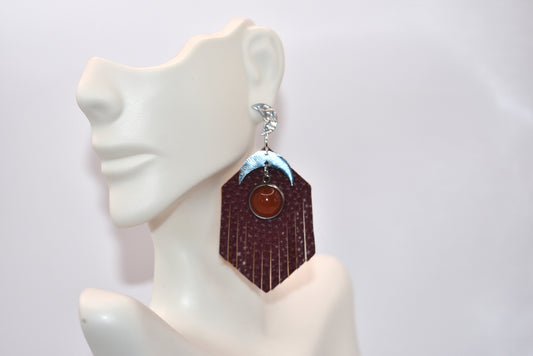 Introducing our Brown Collection! These stainless-steel hypoallergenic posts are perfect for sensitive ears. The brown fringed faux leather background adds a touch of elegance, while the stainless-steel half-moon charm and brown cabochon stone add a unique twist. Gotta have it!