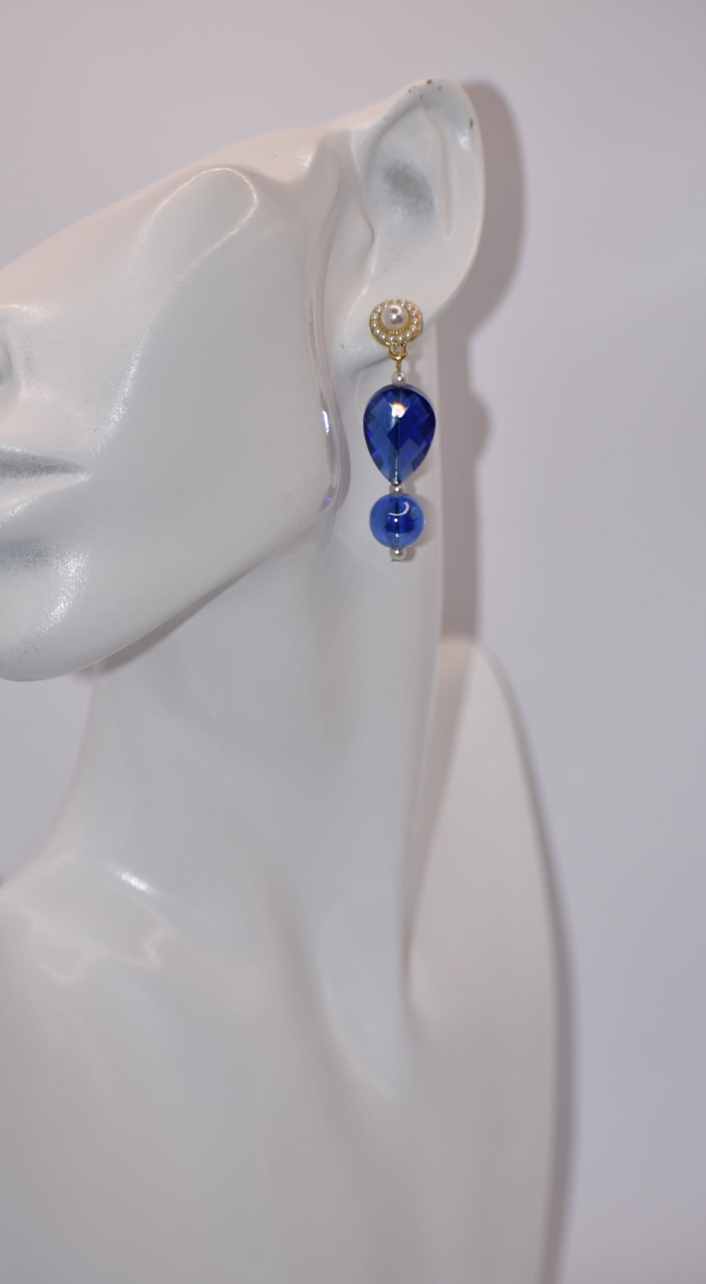 ntroducing our Wedding Collection - the perfect pair for any wedding. These beautiful pearl round posts feature stunning cobalt blue gems with delicate pearl accents. Whether it's for the mother-in-law, mother of the bride, or the bride herself, this one-of-a-kind piece is sure to make anyone fall in love. Don't miss out on this unique and elegant addition to your special day.