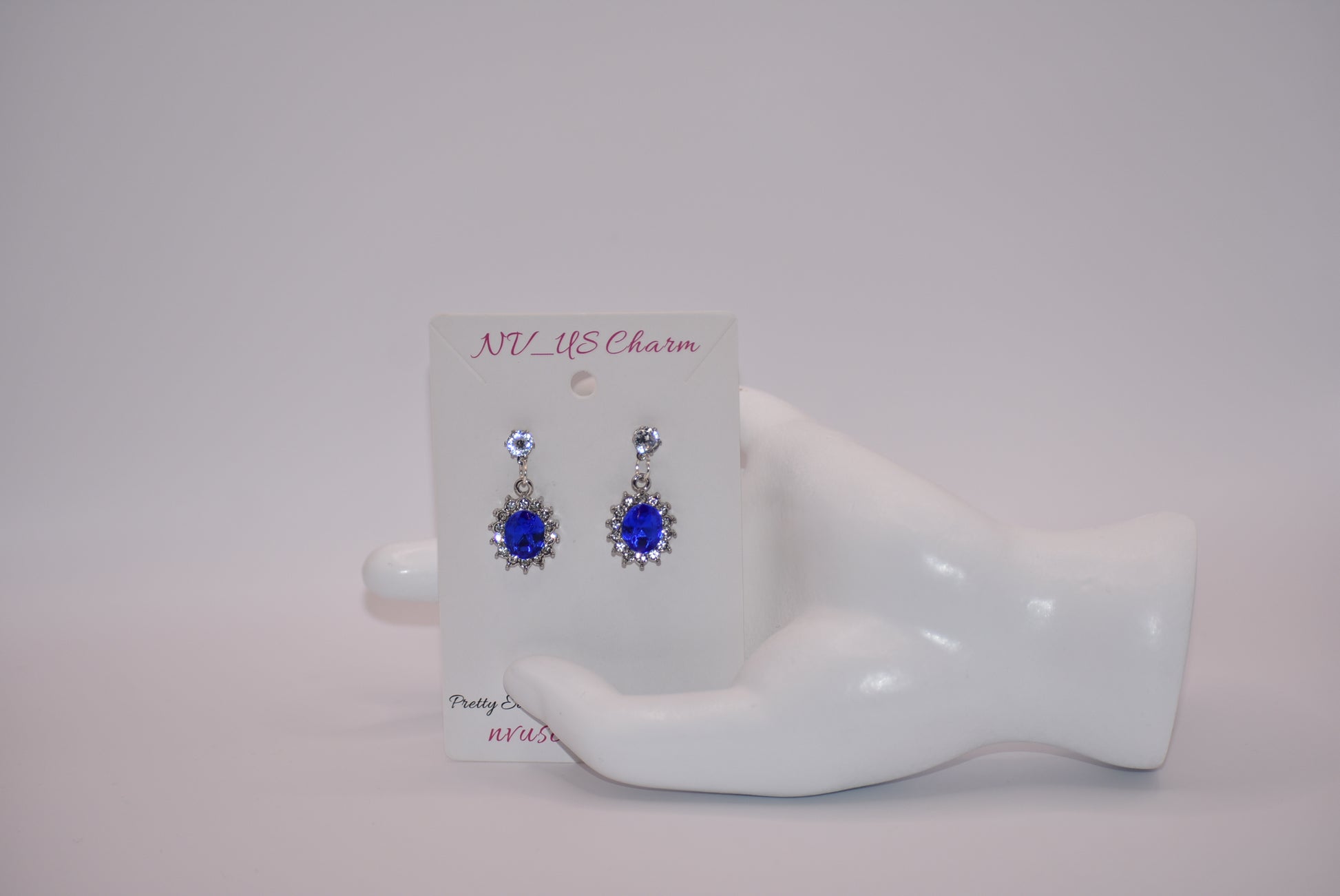 "Add a touch of sparkle to any outfit with our Blue Collection earrings. These hypoallergenic studs feature a pretty cubic zirconia crystal and a stunning cobalt blue gem. Perfect for dressing up or down, they are both comfortable and eye-catching. A must-have addition to any jewelry collection! (Seriously, you won't regret it.)"