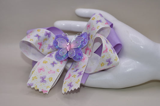 Delightful purple and pink butterflies 🦋 dance across this gorgeous bow! 🎀 Multiple layers of premium ribbon create a stunning design that's sure to turn heads! ✨ The wrapped alligator clip ensures this beauty stays securely in place all day long. 👧 Perfect for adding a touch of whimsy to any outfit! 💜💕