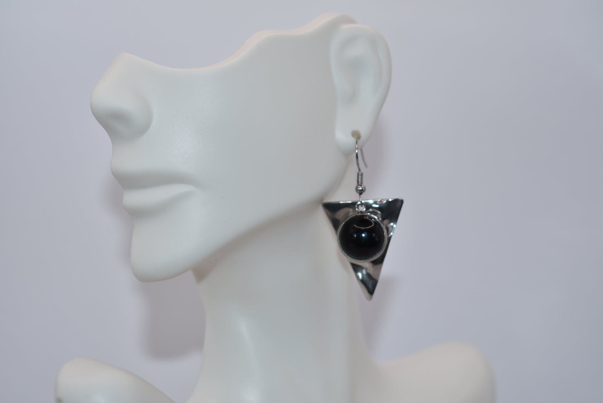 Add a touch of edginess to your wardrobe with our Black Collection! These beautiful cabochon stone earrings feature stainless steel posts and a stylish upside down triangle plate. Perfect for dressing up or down, these earrings are sure to become a staple in your jewelry collection.