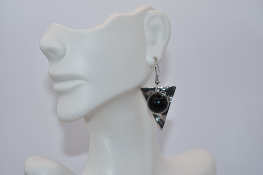 Add a touch of edginess to your wardrobe with our Black Collection! These beautiful cabochon stone earrings feature stainless steel posts and a stylish upside down triangle plate. Perfect for dressing up or down, these earrings are sure to become a staple in your jewelry collection.