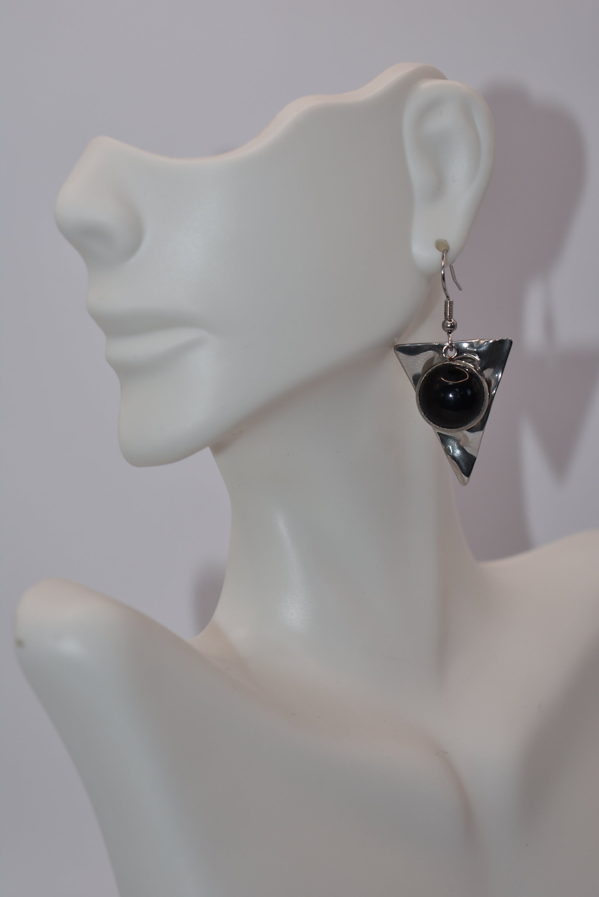 Add a touch of edginess to your wardrobe with our Black Collection! These beautiful cabochon stone earrings feature stainless steel posts and a stylish upside down triangle plate. Perfect for dressing up or down, these earrings are sure to become a staple in your jewelry collection.