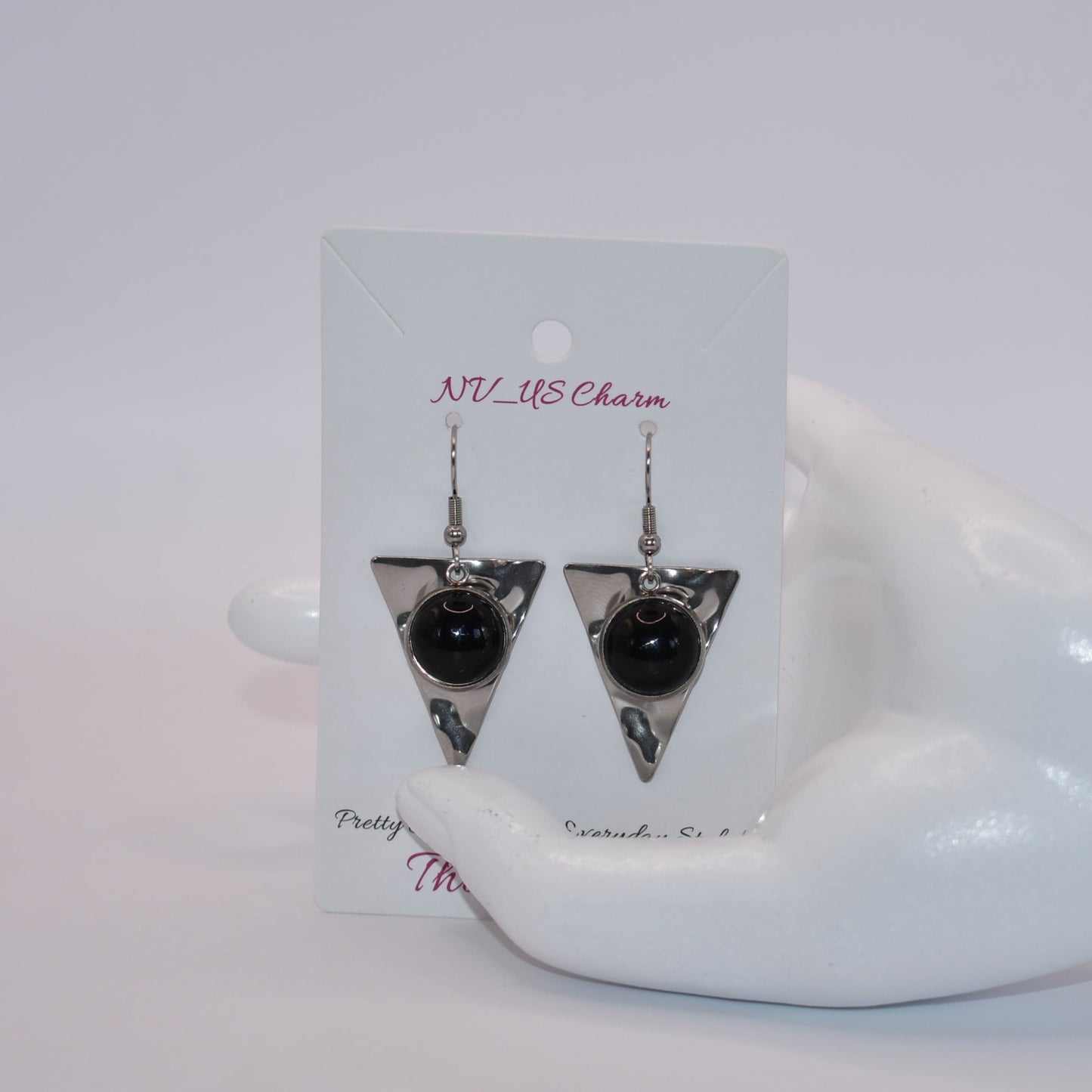 Add a touch of edginess to your wardrobe with our Black Collection! These beautiful cabochon stone earrings feature stainless steel posts and a stylish upside down triangle plate. Perfect for dressing up or down, these earrings are sure to become a staple in your jewelry collection.