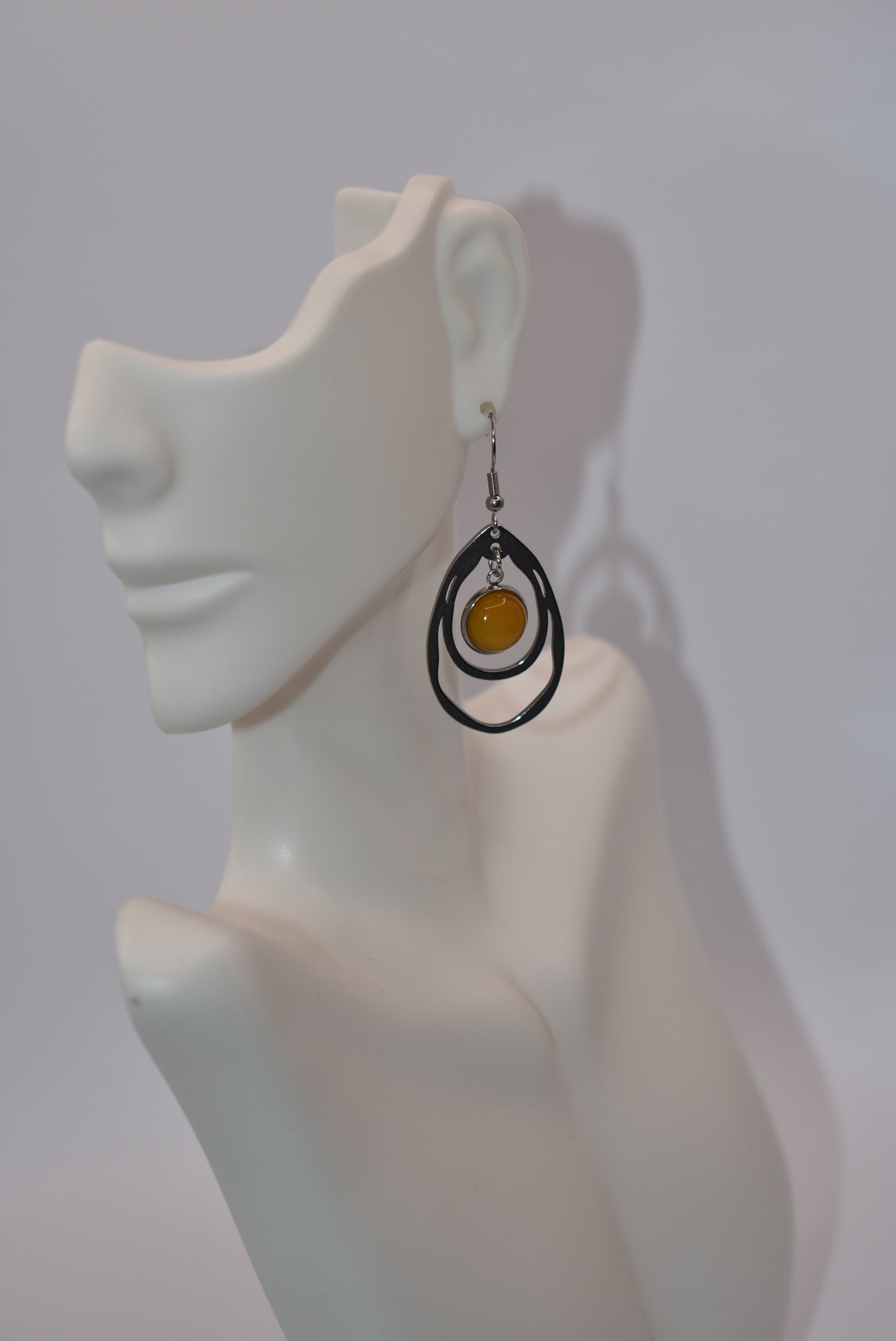 Add a touch of sunshine to your outfit with our Yellow Collection earrings. Made with hypoallergenic stainless-steel hooks, these beautiful hanging earrings feature a stunning cabochon stone in a bright and bold yellow hue. So comfortable and stylish, they'll make your look pop!