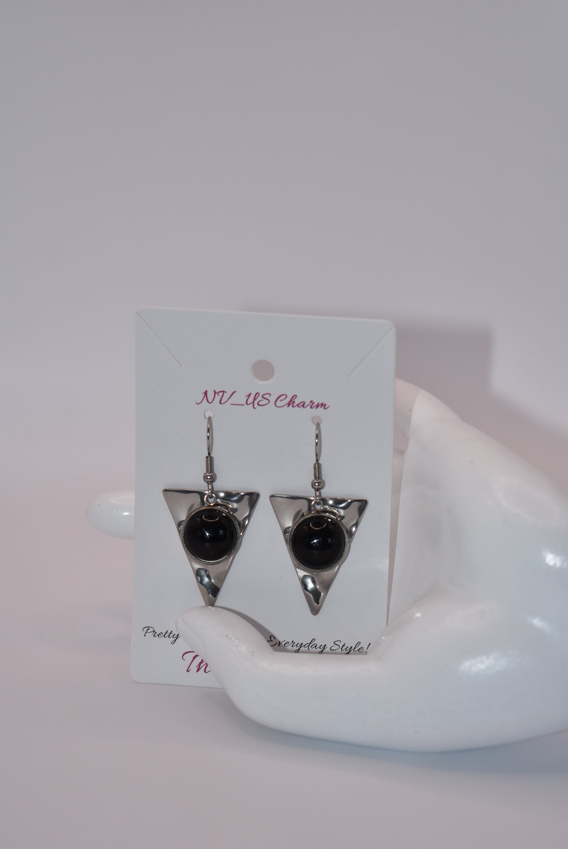 Add a touch of edginess to your wardrobe with our Black Collection! These beautiful cabochon stone earrings feature stainless steel posts and a stylish upside down triangle plate. Perfect for dressing up or down, these earrings are sure to become a staple in your jewelry collection.