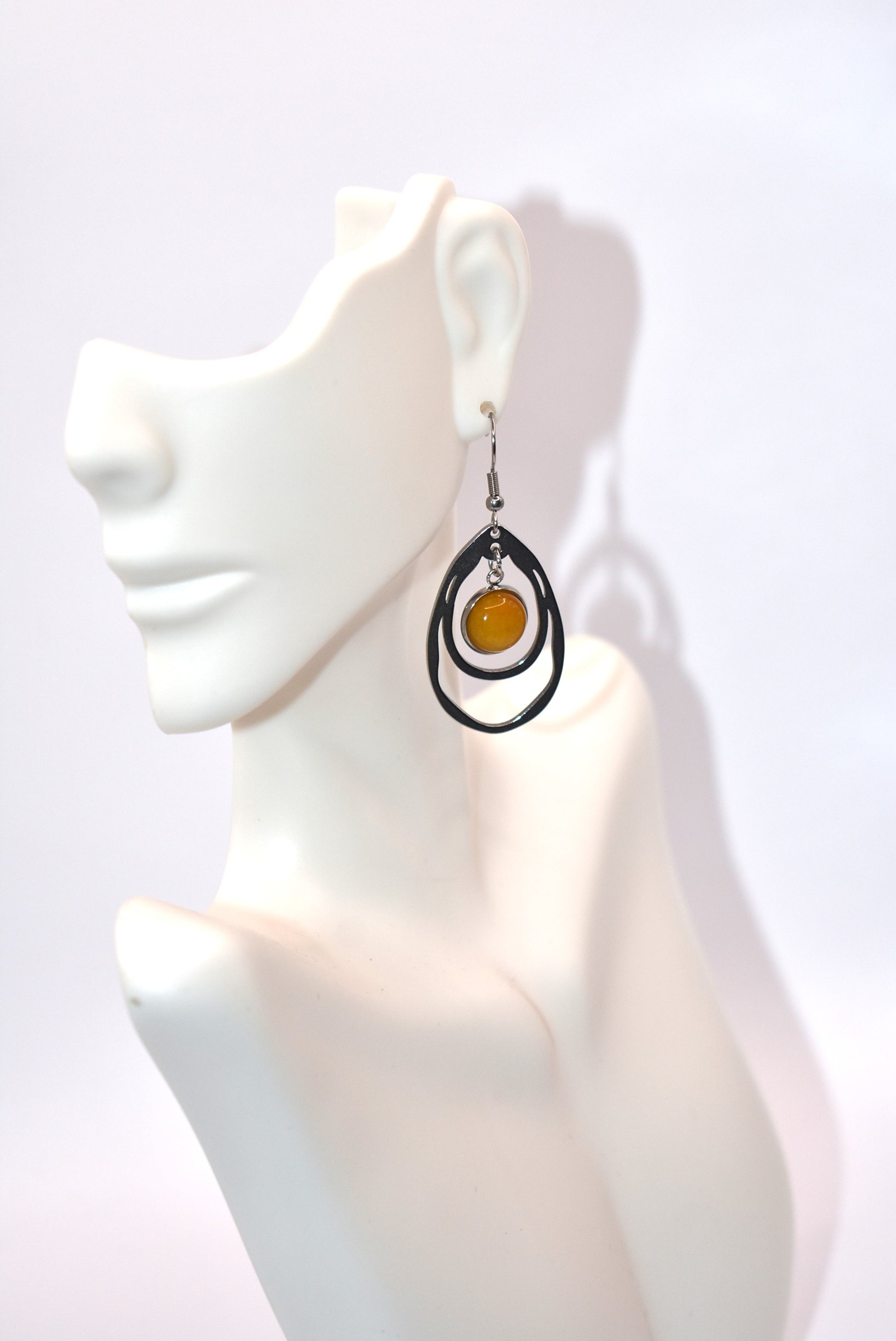 Add a touch of sunshine to your outfit with our Yellow Collection earrings. Made with hypoallergenic stainless-steel hooks, these beautiful hanging earrings feature a stunning cabochon stone in a bright and bold yellow hue. So comfortable and stylish, they'll make your look pop!