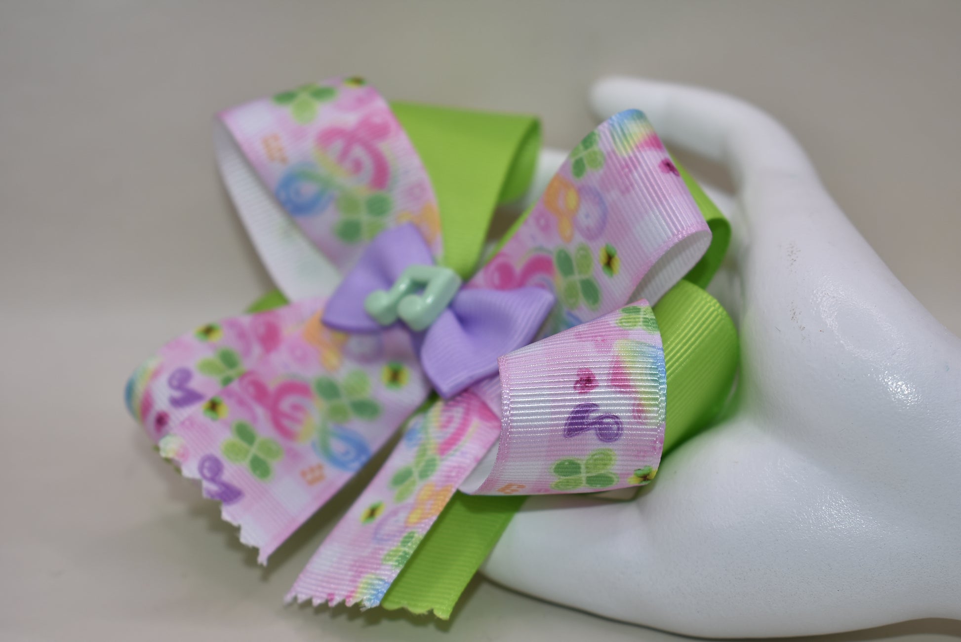 Perfect for your little music enthusiast! 🎵 This adorable bow features musical ribbon topped with a cute note charm, creating a harmonious accessory she'll love! 🎀 Securely attached to a wrapped alligator clip for comfortable all-day wear without slipping. 🎶 Let her show off her musical spirit with this playful addition to Nana's Collection! 💕