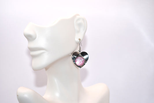 Fall head over heels for our Pink Collection! These heart shaped earrings feature a stunning pink multicolored cabochon in the middle, nestled within a stainless-steel backdrop. Lightweight and comfy on the ears, they're perfect for everyday wear.