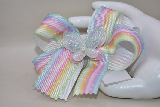 Elevate your little one's style with this enchanting pastel rainbow ribbon bow! 🌈✨ Topped with a sparkly butterfly that catches the light, this adorable hair accessory brings magical charm to any outfit. 🦋 The secure alligator clip ensures it stays put through all her adventures! Perfect for your color-loving princess who wants to stand out with playful flair. 💕 #NanasCollection
