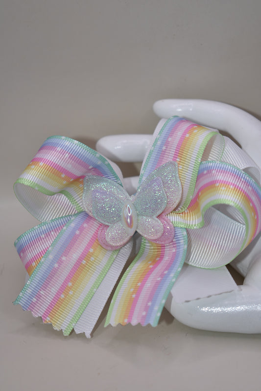 Elevate your little one's style with this enchanting pastel rainbow ribbon bow! 🌈✨ Topped with a sparkly butterfly that catches the light, this adorable hair accessory brings magical charm to any outfit. 🦋 The secure alligator clip ensures it stays put through all her adventures! Perfect for your color-loving princess who wants to stand out with playful flair. 💕 #NanasCollection