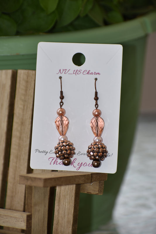 The Brown Collection 12 features stunning yet lightweight copper earrings with a unique combination of peach and copper beads and pearls. Hang in perfect proportions at the perfect length, these beautiful earrings are the perfect finishing touch to any ensemble.