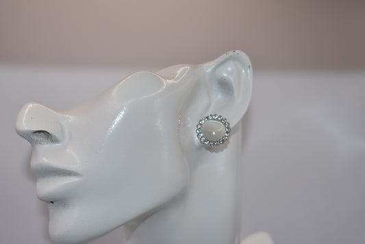 Introducing our White Collection! These unique earrings are a perfect addition to any outfit, featuring stunning white gems surrounded by sparkling white crystals. With a hypoallergenic post for comfort, they're perfect for anyone seeking something different.