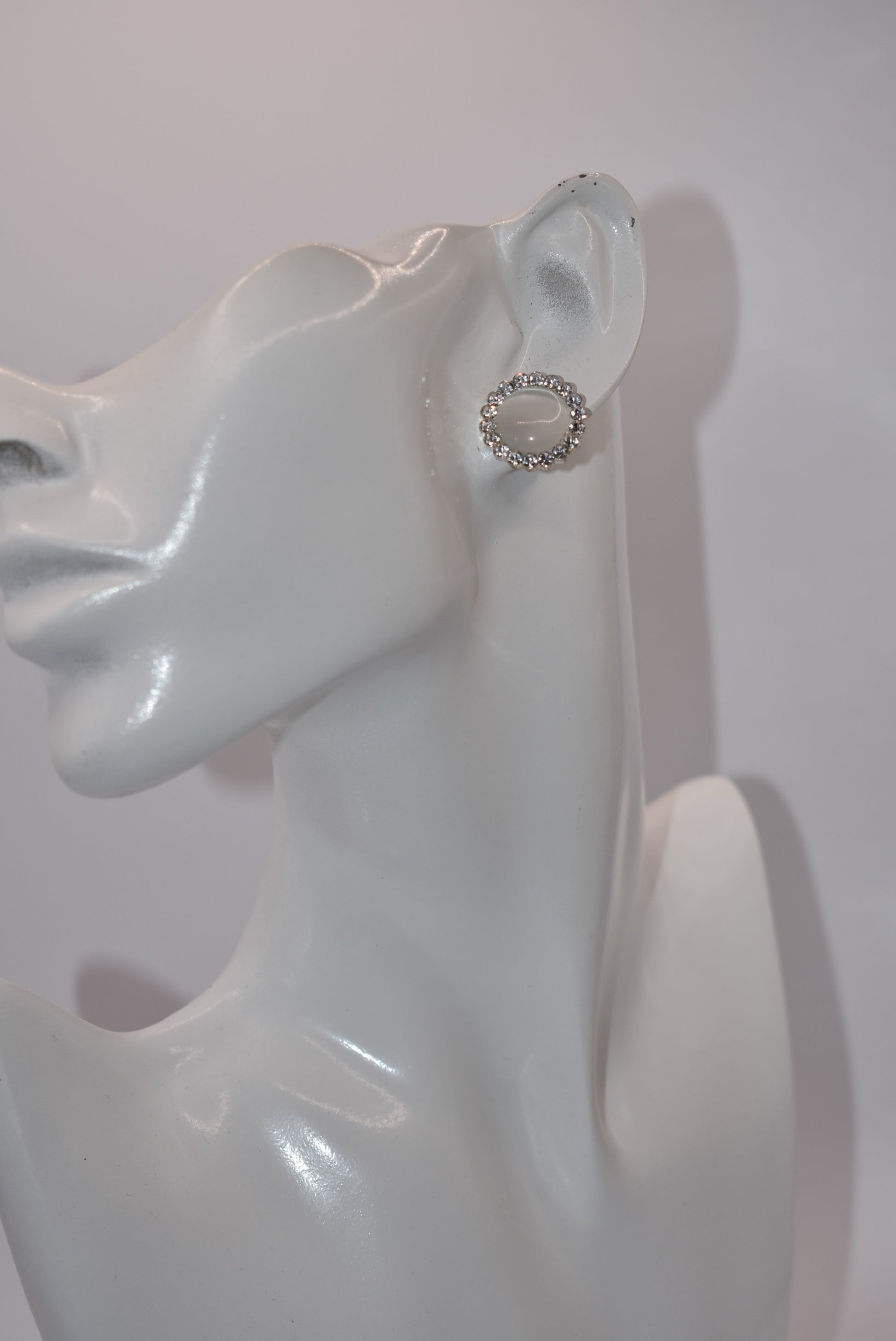 Introducing our White Collection! These unique earrings are a perfect addition to any outfit, featuring stunning white gems surrounded by sparkling white crystals. With a hypoallergenic post for comfort, they're perfect for anyone seeking something different.