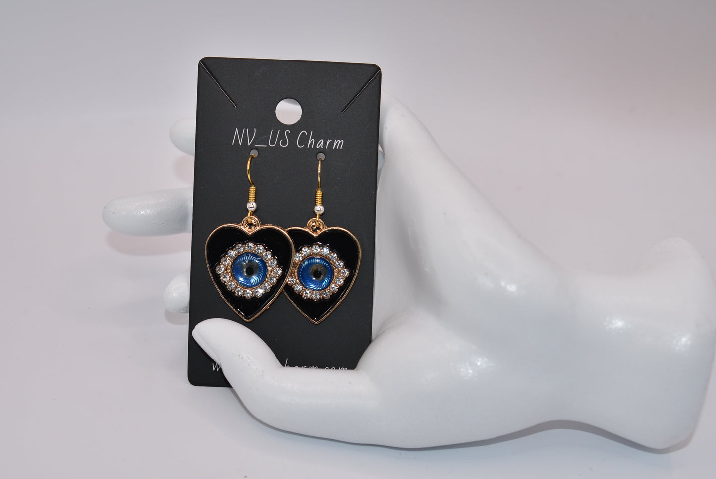 Introducing our Blue Collection, featuring our stunning evil eye earrings. These hypoallergenic earrings not only make a statement, but also provide protection from evil eyes. The black background makes the evil eye pop, adding a touch of beauty to your look. (You'll literally be turning heads)