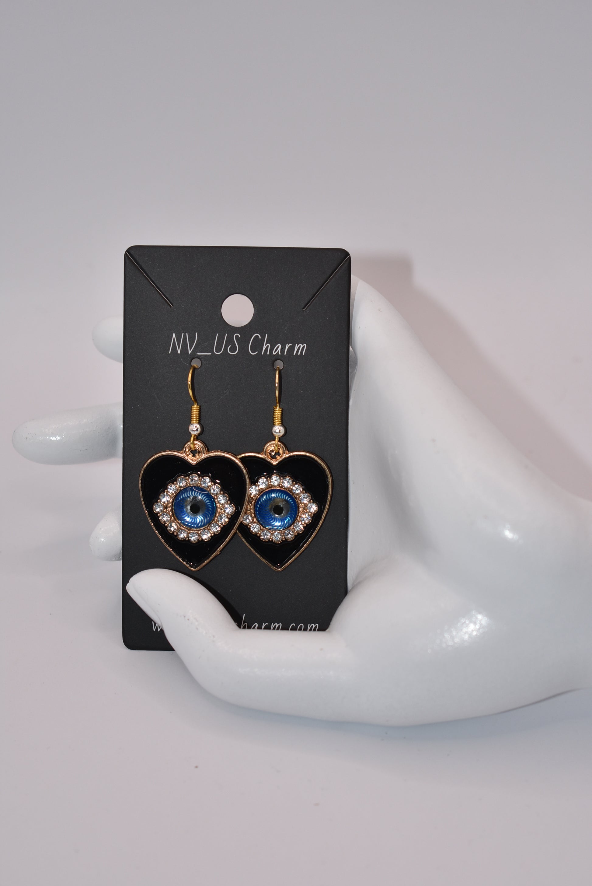 Introducing our Blue Collection, featuring our stunning evil eye earrings. These hypoallergenic earrings not only make a statement, but also provide protection from evil eyes. The black background makes the evil eye pop, adding a touch of beauty to your look. (You'll literally be turning heads)