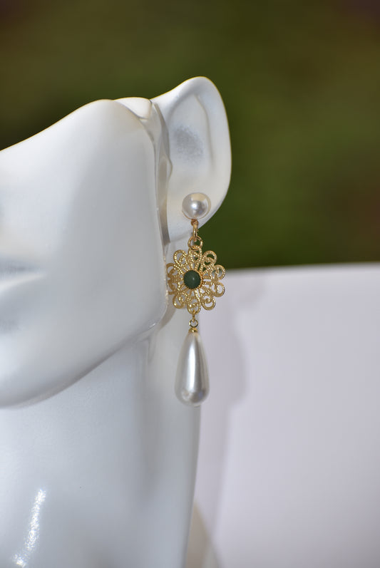 This wedding collection features a stunning combination of timeless elegance and modern innovation. The hypoallergenic pearl posts secure a beautiful gold filigree charm with a jade center, topped off with a delicate pearl drop. Perfect for the special day and beyond.