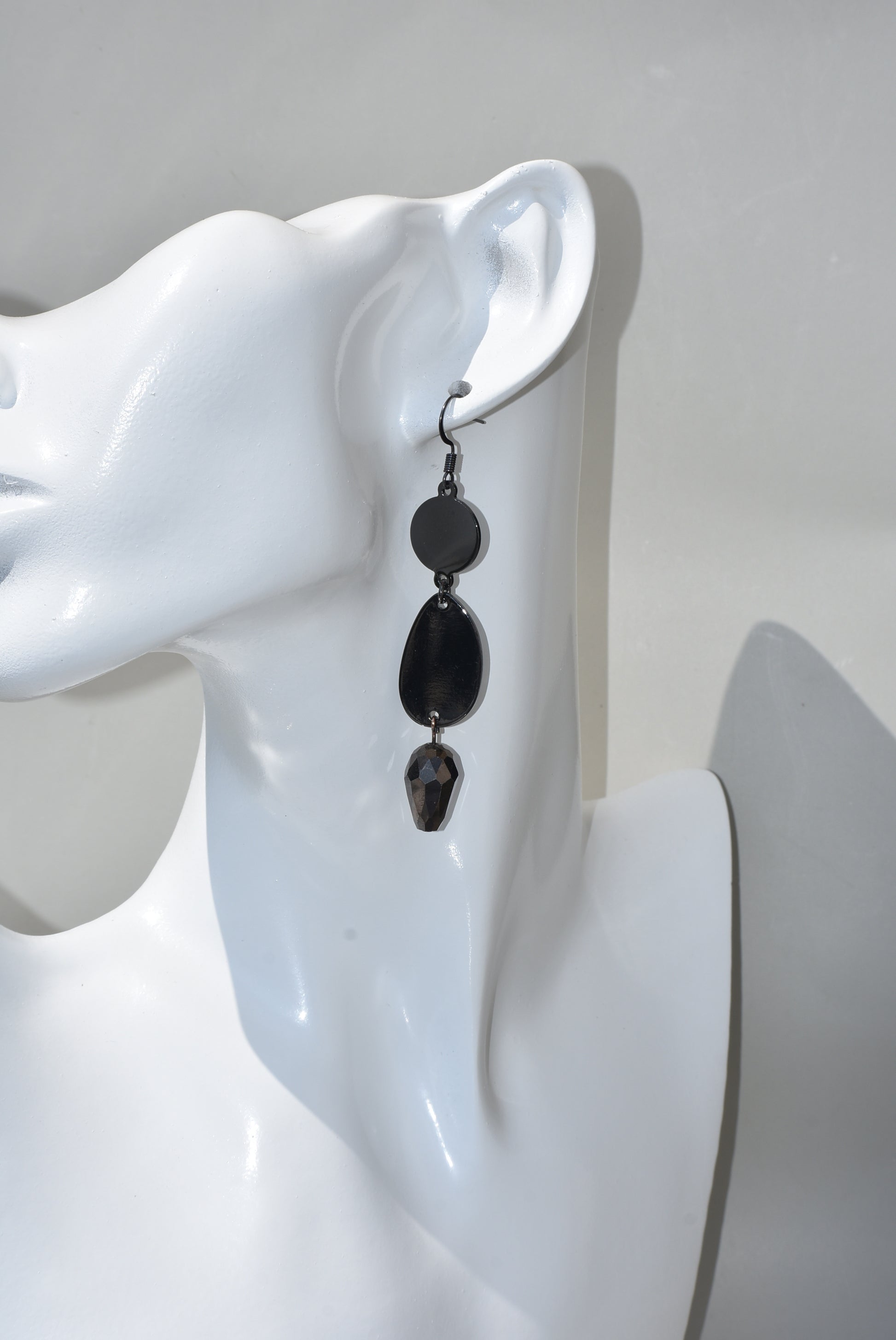 he Black Collection is an excellent accessory choice for any outfit. Crafted from black hooks, these stylish and pretty earrings feature a two-tier design for a dazzling effect. The lower portion of the earrings is adorned with a purple and black crystal, adding a glamorous finish.