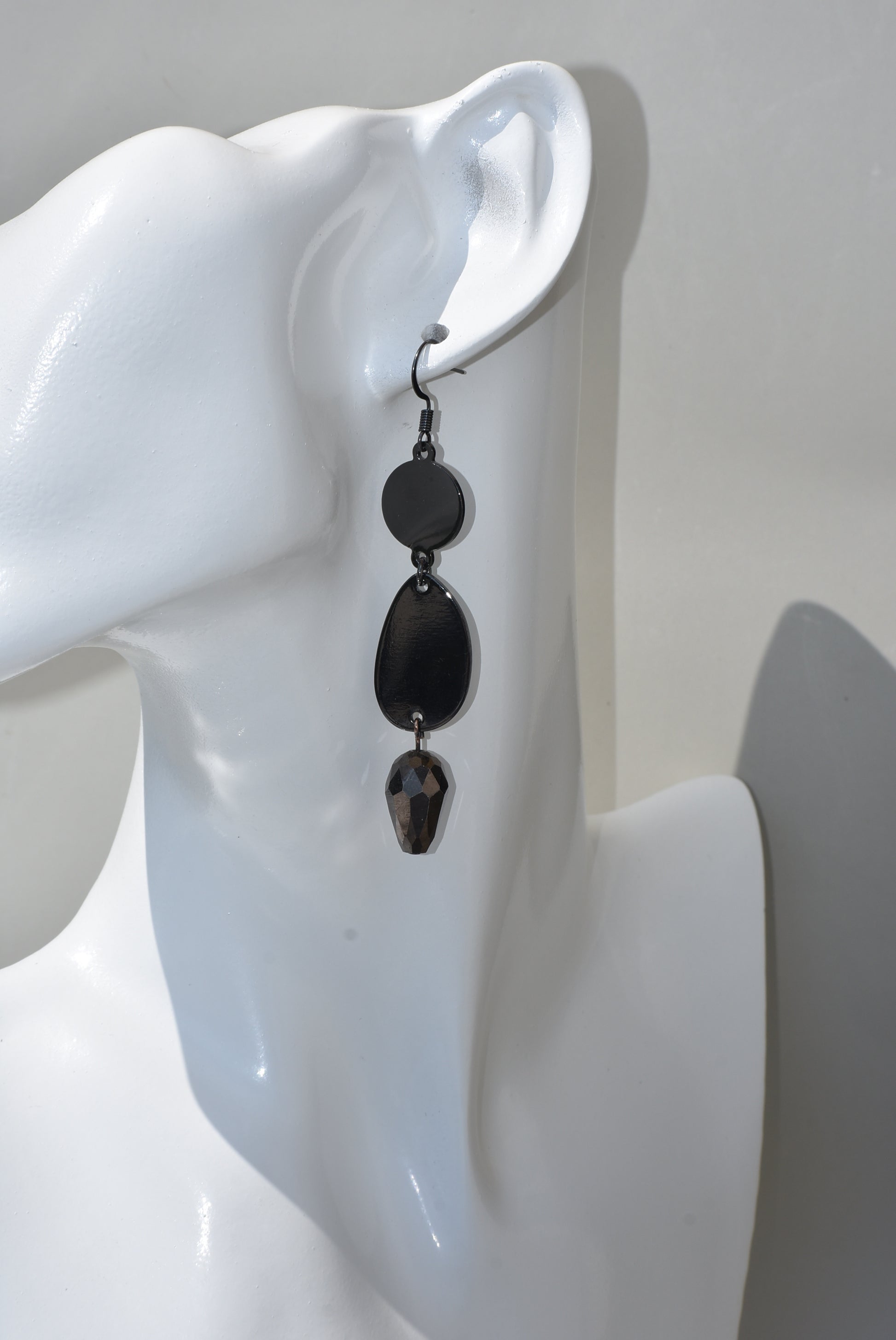 he Black Collection is an excellent accessory choice for any outfit. Crafted from black hooks, these stylish and pretty earrings feature a two-tier design for a dazzling effect. The lower portion of the earrings is adorned with a purple and black crystal, adding a glamorous finish.