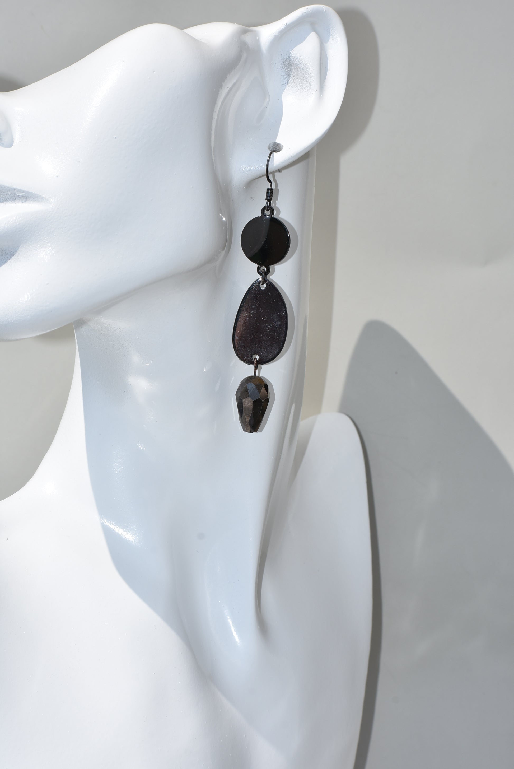 he Black Collection is an excellent accessory choice for any outfit. Crafted from black hooks, these stylish and pretty earrings feature a two-tier design for a dazzling effect. The lower portion of the earrings is adorned with a purple and black crystal, adding a glamorous finish.