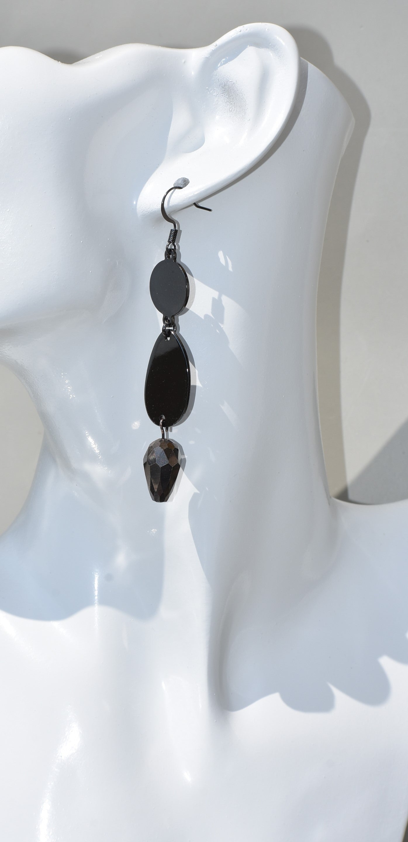 he Black Collection is an excellent accessory choice for any outfit. Crafted from black hooks, these stylish and pretty earrings feature a two-tier design for a dazzling effect. The lower portion of the earrings is adorned with a purple and black crystal, adding a glamorous finish.