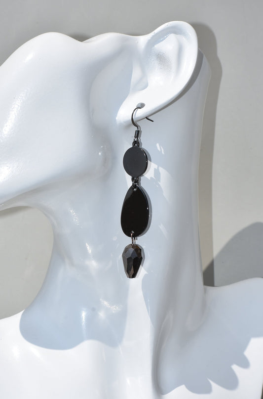 he Black Collection is an excellent accessory choice for any outfit. Crafted from black hooks, these stylish and pretty earrings feature a two-tier design for a dazzling effect. The lower portion of the earrings is adorned with a purple and black crystal, adding a glamorous finish.