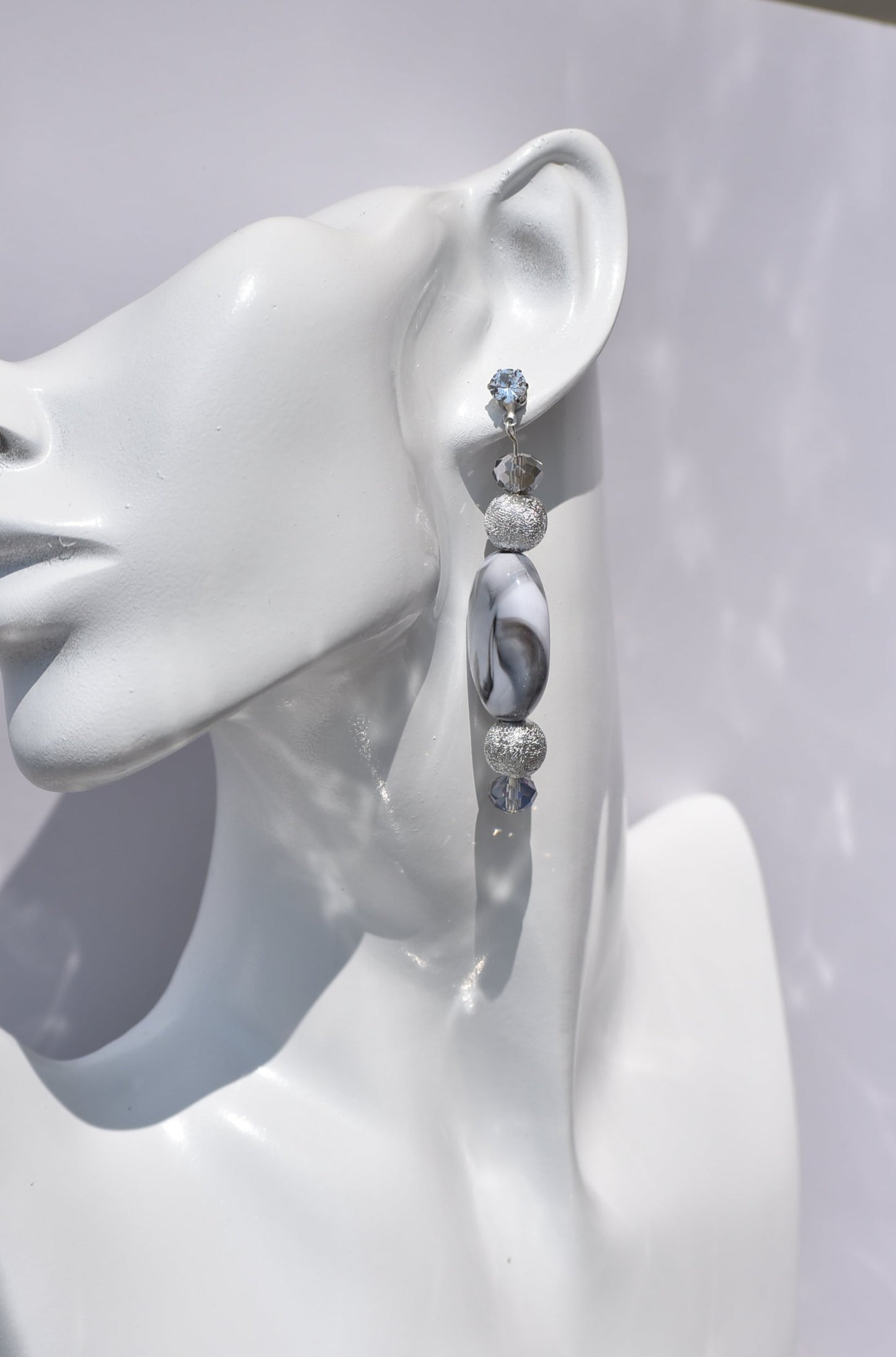 You will fall in love with these beautiful one-of-a-kind gray and silver earrings.  They are the perfect combination to wear on your ears for that special evening out.  They shimmer and compliment anything you will be wearing.  They sit on the ear with a crystal post for a little extra sparkle.  