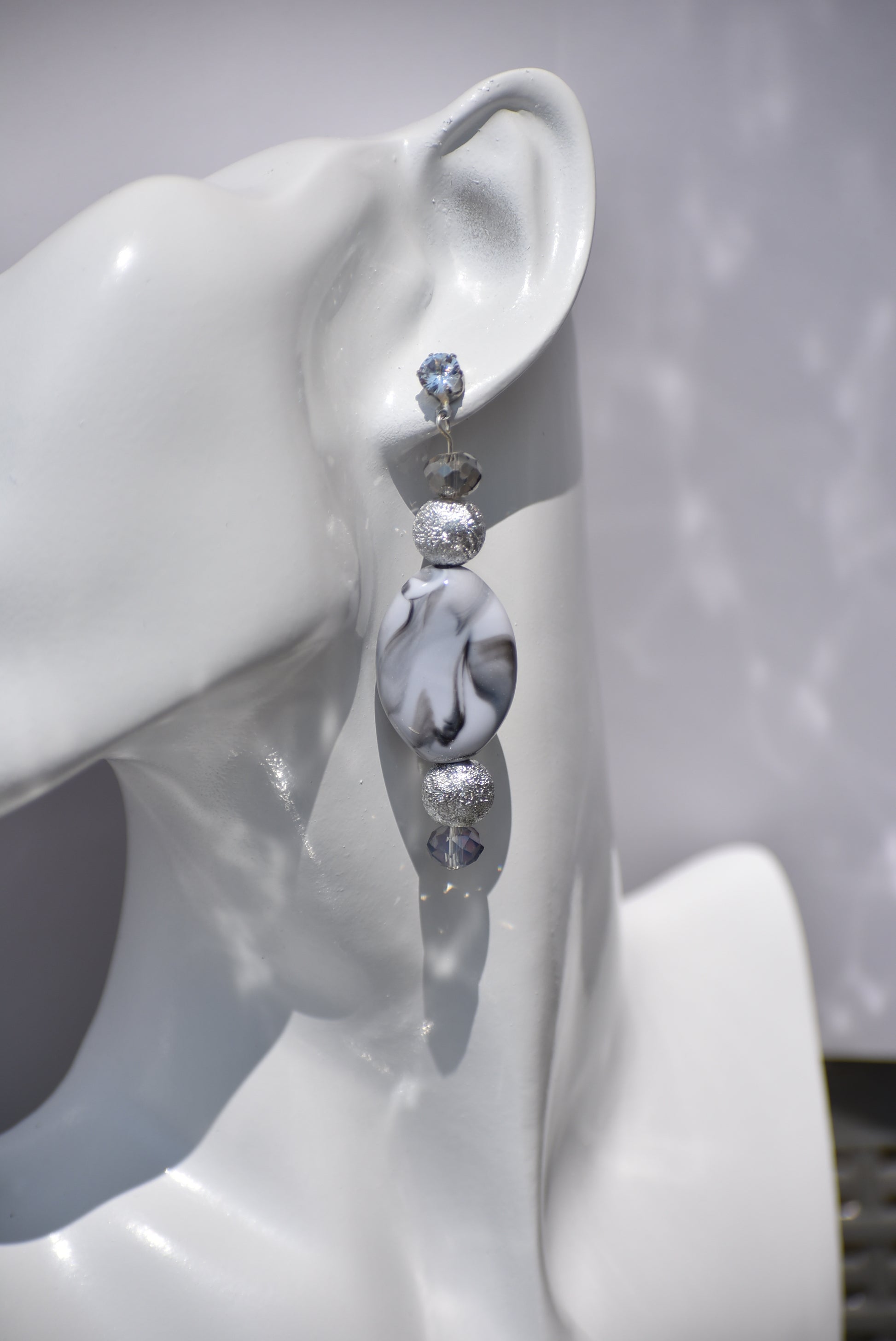 You will fall in love with these beautiful one-of-a-kind gray and silver earrings.  They are the perfect combination to wear on your ears for that special evening out.  They shimmer and compliment anything you will be wearing.  They sit on the ear with a crystal post for a little extra sparkle.  