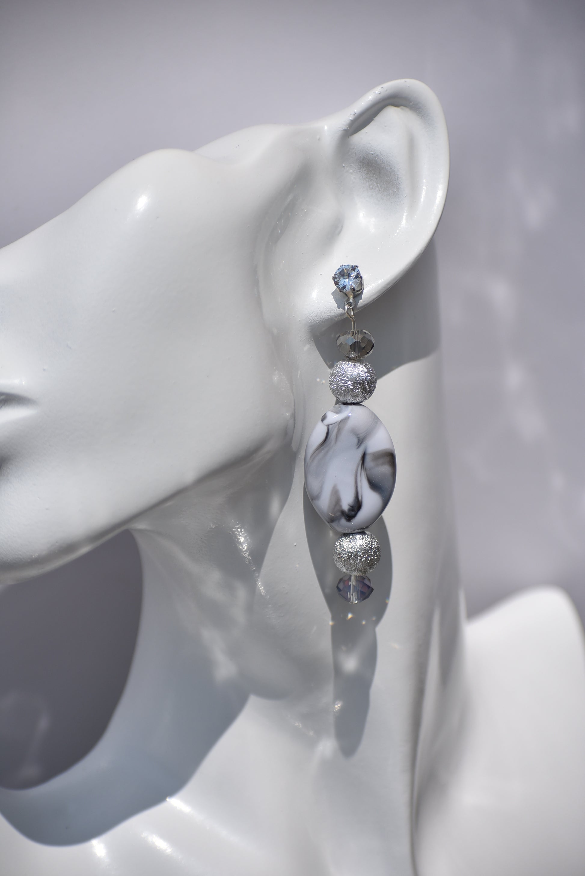 You will fall in love with these beautiful one-of-a-kind gray and silver earrings.  They are the perfect combination to wear on your ears for that special evening out.  They shimmer and compliment anything you will be wearing.  They sit on the ear with a crystal post for a little extra sparkle.  