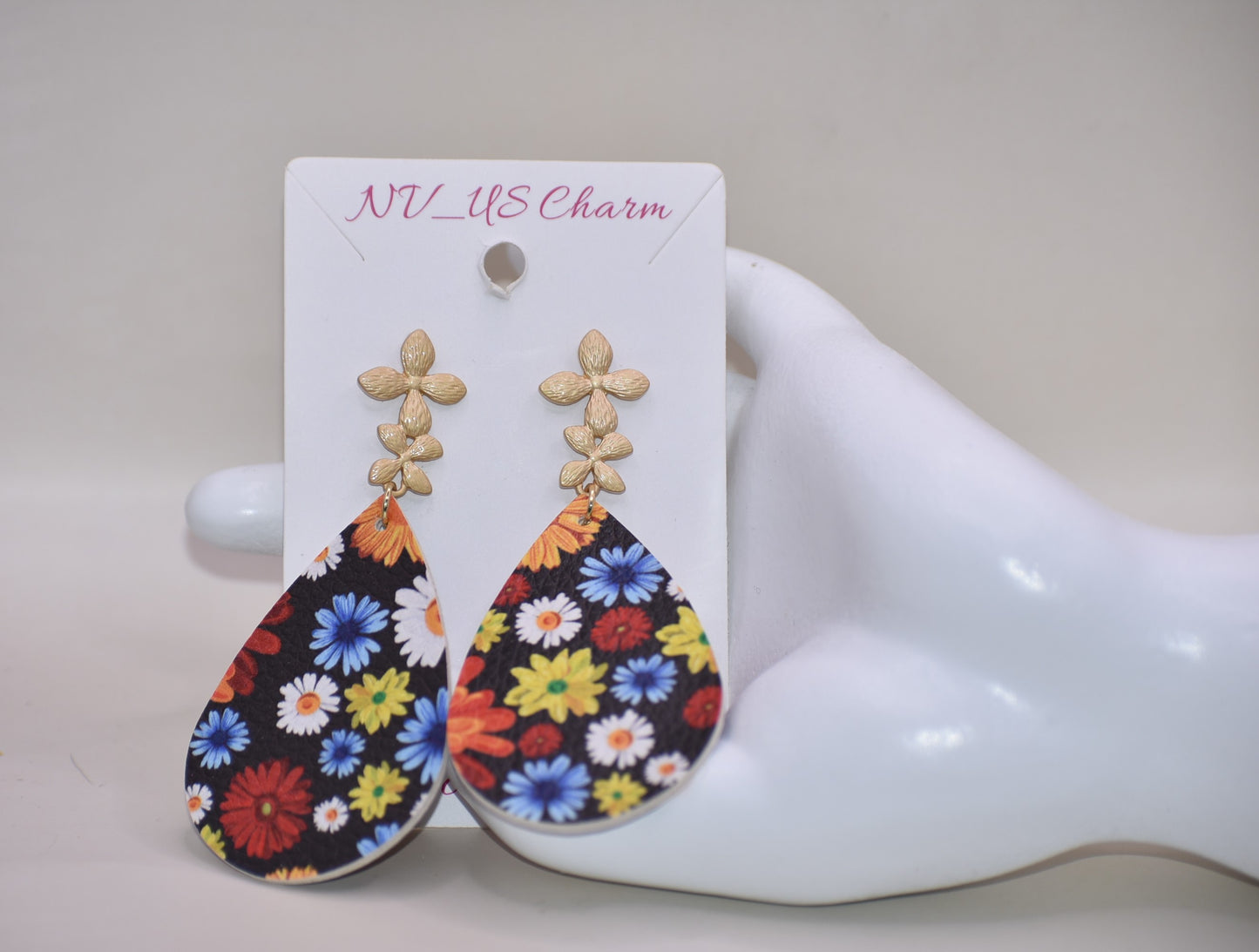 Add a pop of color and quirkiness to any outfit with our Key West Collection earrings! The super fun and bright design features a black background with a vibrant, multi-colored flowered pattern. The unique gold posts add a touch of whimsy, making these earrings truly one-of-a-kind. Get ready to fall in love with these unique flower posts!" 🌺💛