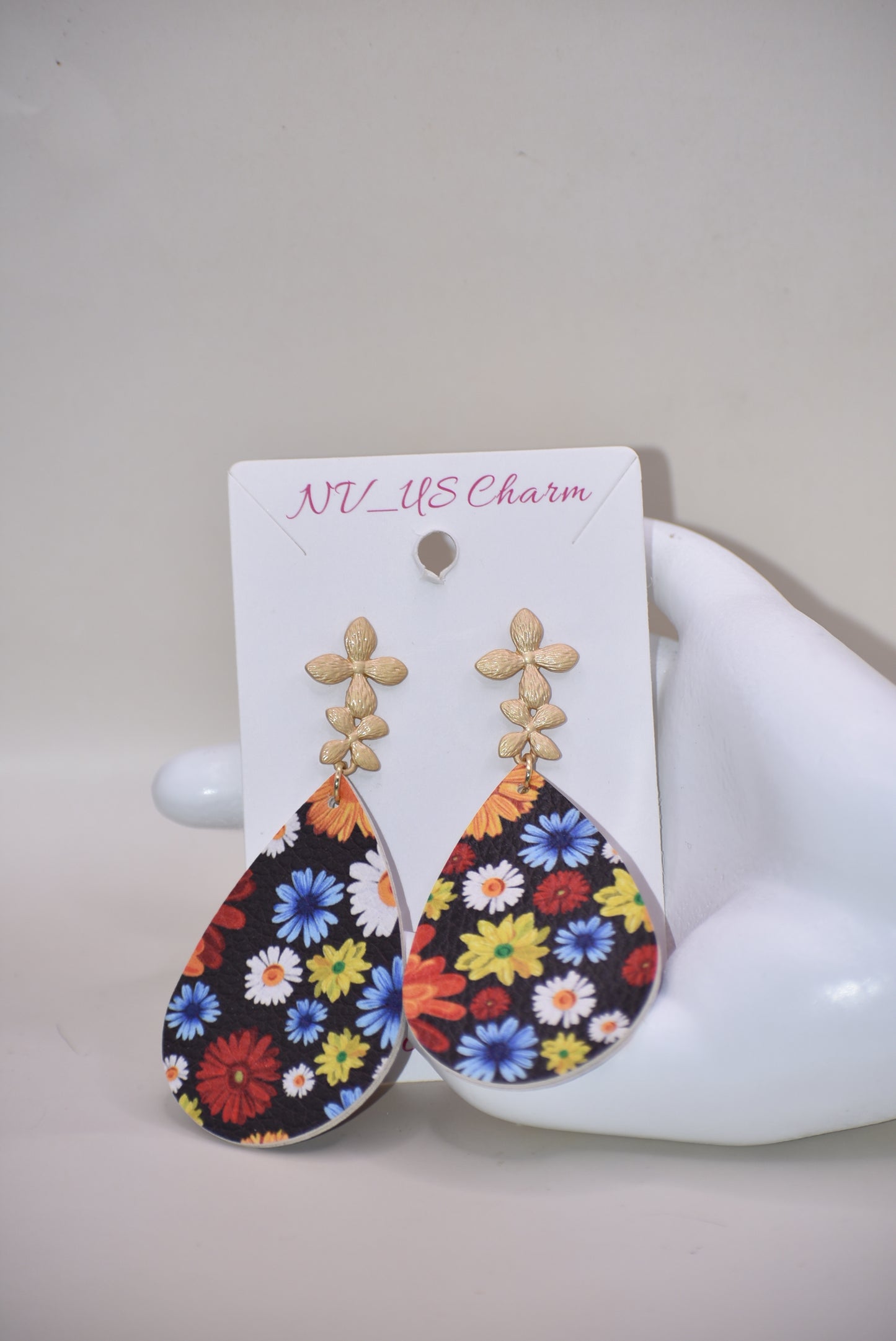 Add a pop of color and quirkiness to any outfit with our Key West Collection earrings! The super fun and bright design features a black background with a vibrant, multi-colored flowered pattern. The unique gold posts add a touch of whimsy, making these earrings truly one-of-a-kind. Get ready to fall in love with these unique flower posts!" 🌺💛