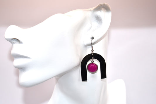 Get ready to add a pop of color to your wardrobe with the Pink Collection! Featuring a hot pink Cabochon stone, stainless steel hanging hooks, and a u-shaped stainless-steel shape that surrounds the stone, these earrings are not only super fun but also super comfortable and stylish. Perfect for any outfit, these earrings are a must-have for a playful and quirky look.