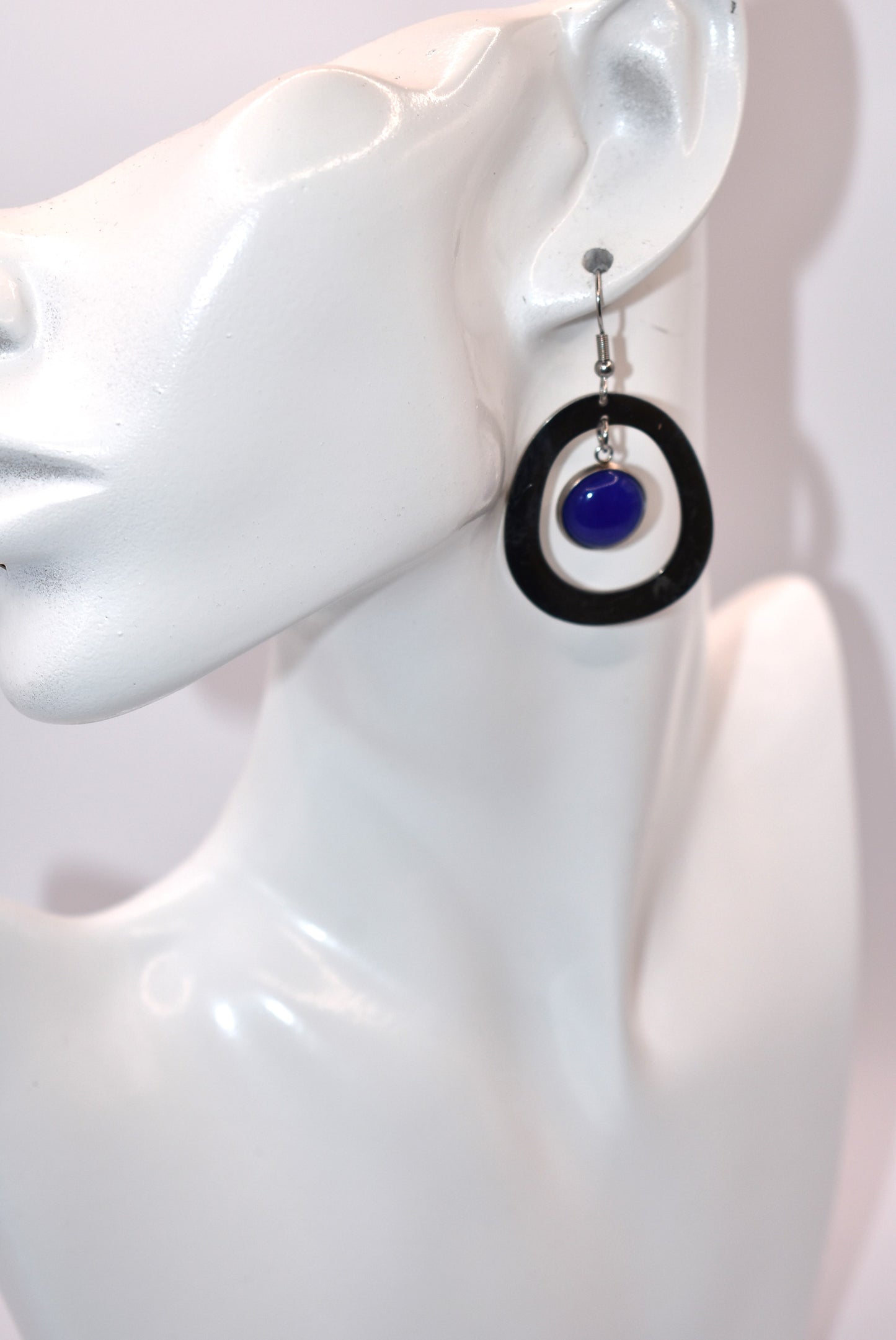 Add a pop of color to your outfit with our gorgeous Blue Collection earrings. Featuring a stunning blue cabochon stone, these earrings are both stylish and comfortable with their stainless-steel posts. The unique oval pattern adds a touch of sophistication. A must-have for any fashion-forward individual!