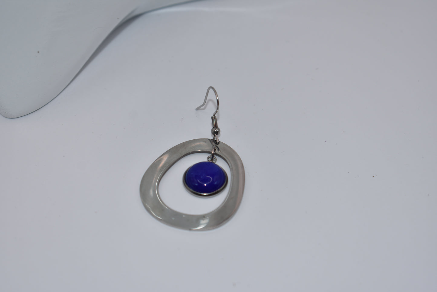 Add a pop of color to your outfit with our gorgeous Blue Collection earrings. Featuring a stunning blue cabochon stone, these earrings are both stylish and comfortable with their stainless-steel posts. The unique oval pattern adds a touch of sophistication. A must-have for any fashion-forward individual!