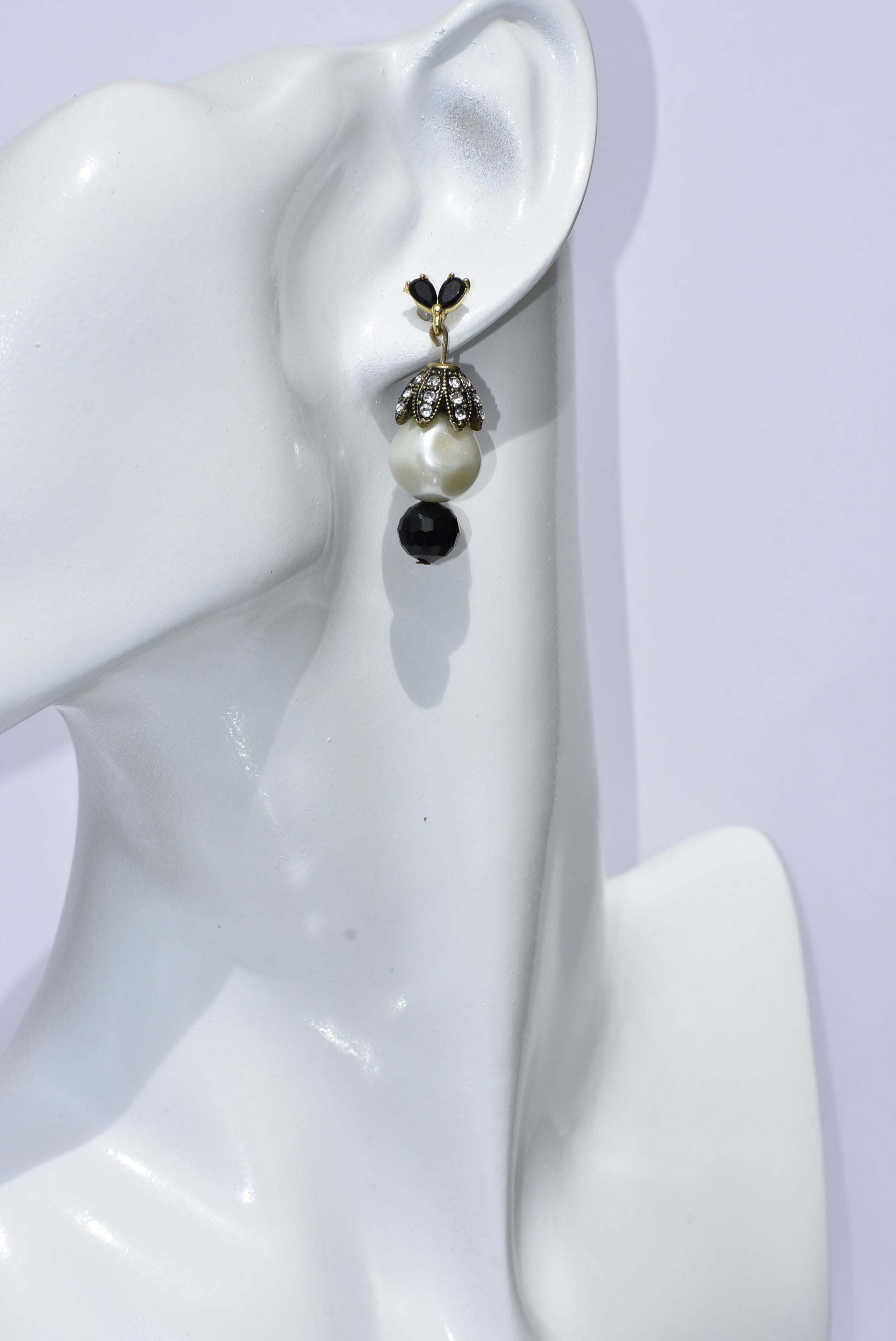 These Beautiful Black crystal and gold posts will charm you! The big pearl, crowned with crystals, is accentuated with a pretty black bead at the bottom. Whether you dress up or down, these earrings will win your heart!