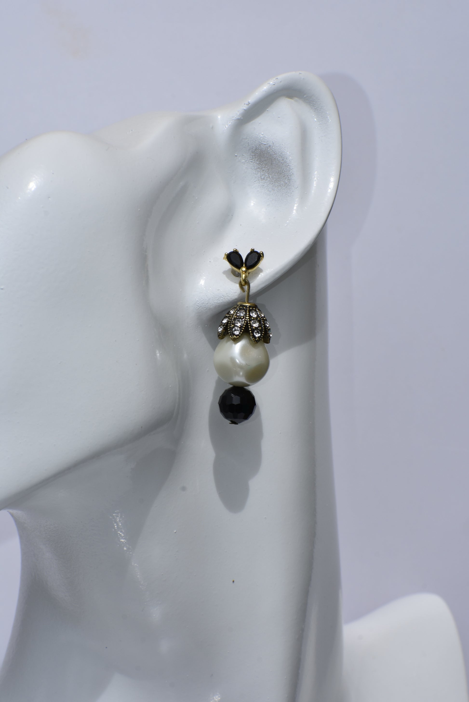 These Beautiful Black crystal and gold posts will charm you! The big pearl, crowned with crystals, is accentuated with a pretty black bead at the bottom. Whether you dress up or down, these earrings will win your heart!