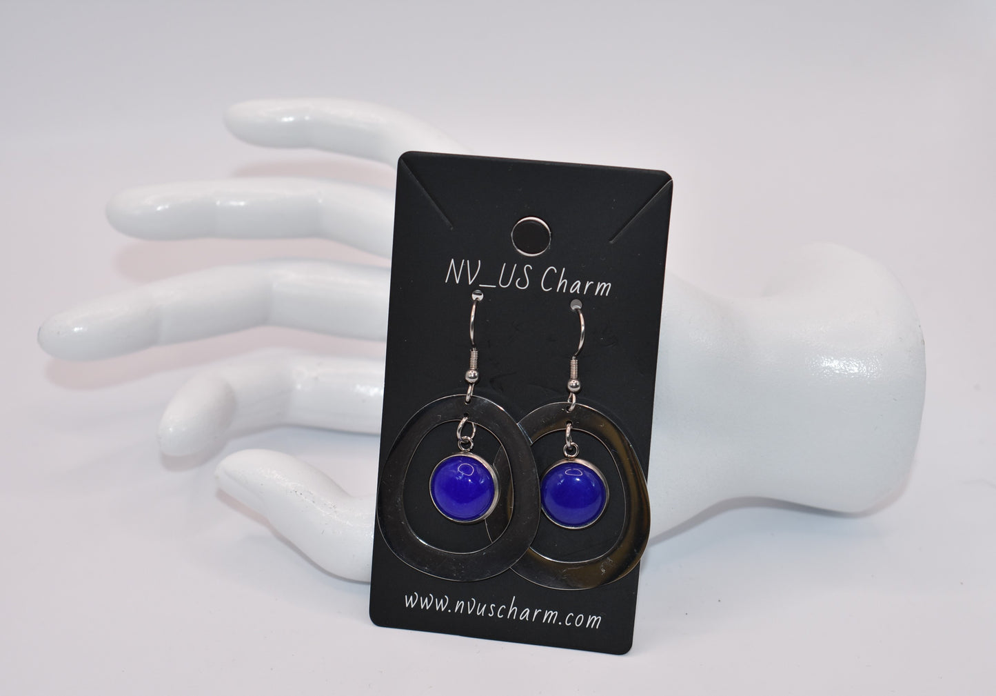 Add a pop of color to your outfit with our gorgeous Blue Collection earrings. Featuring a stunning blue cabochon stone, these earrings are both stylish and comfortable with their stainless-steel posts. The unique oval pattern adds a touch of sophistication. A must-have for any fashion-forward individual!