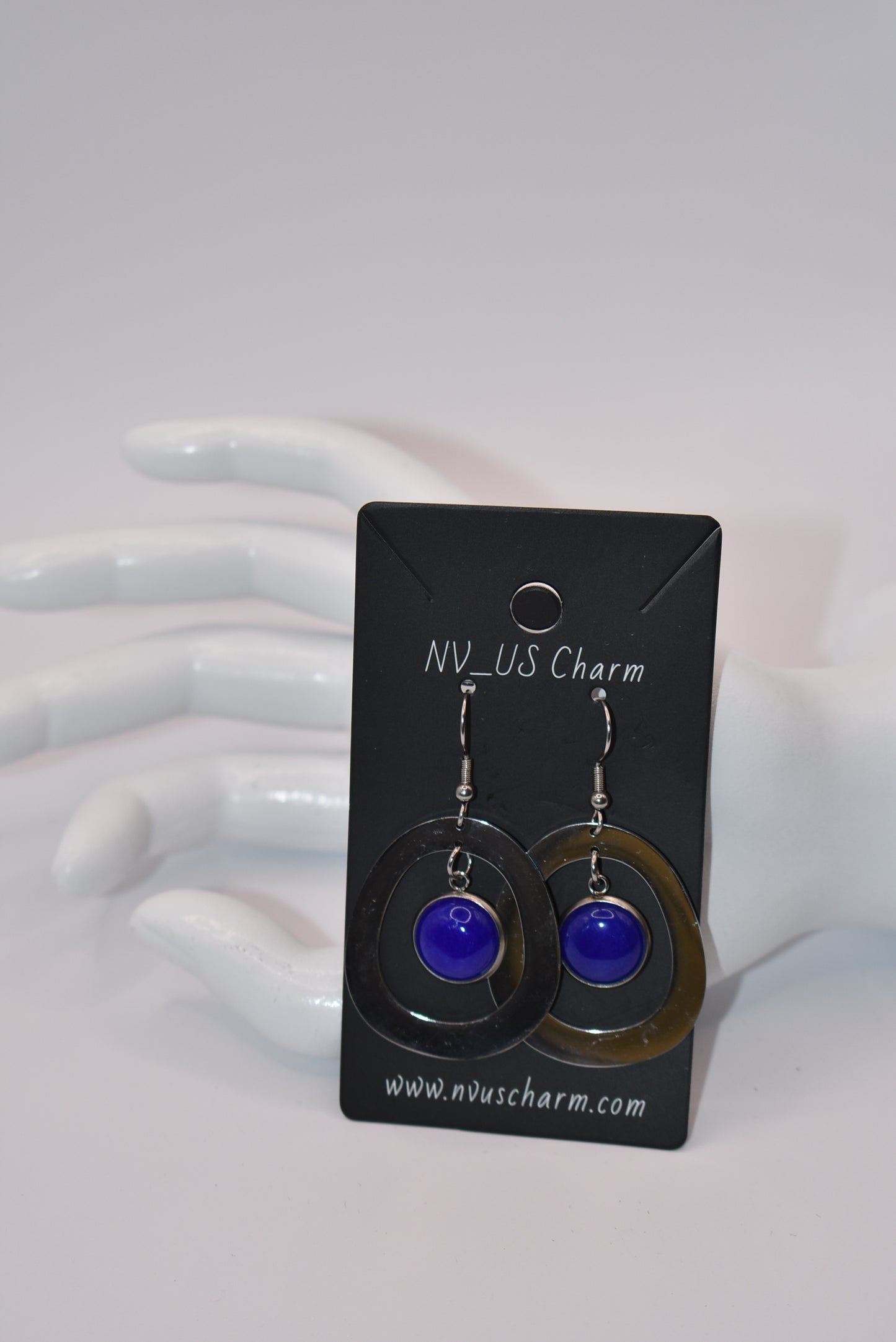 Add a pop of color to your outfit with our gorgeous Blue Collection earrings. Featuring a stunning blue cabochon stone, these earrings are both stylish and comfortable with their stainless-steel posts. The unique oval pattern adds a touch of sophistication. A must-have for any fashion-forward individual!