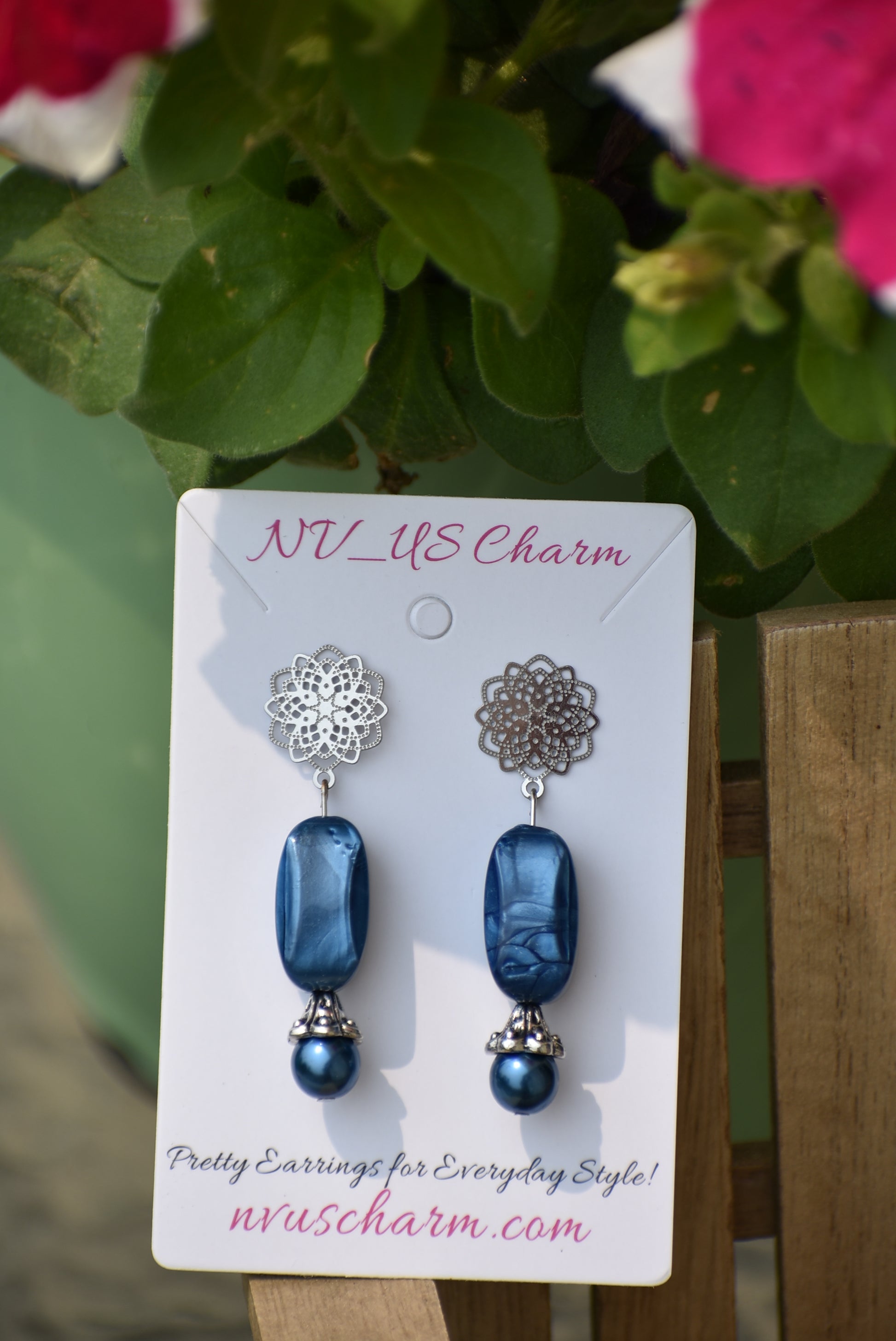 The Blue Collection 12 earrings are a unique and timeless piece crafted with beautiful sapphire blue pearl and beads, coupled with a silver filigree post. With their elegant and classic design, you'll be sure to turn heads.