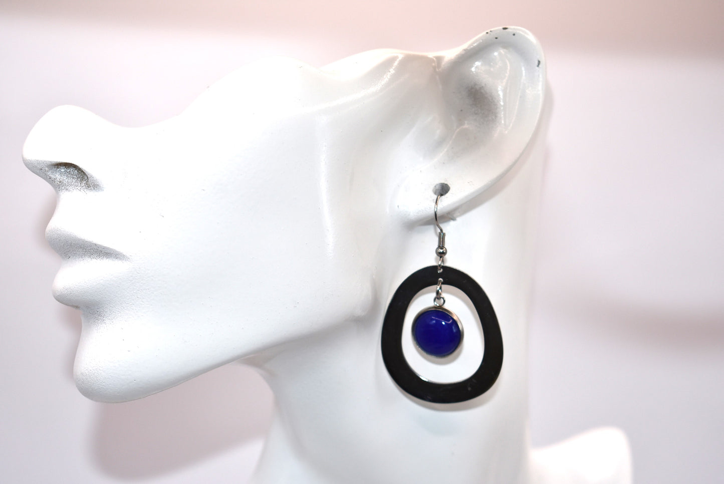 Add a pop of color to your outfit with our gorgeous Blue Collection earrings. Featuring a stunning blue cabochon stone, these earrings are both stylish and comfortable with their stainless-steel posts. The unique oval pattern adds a touch of sophistication. A must-have for any fashion-forward individual!