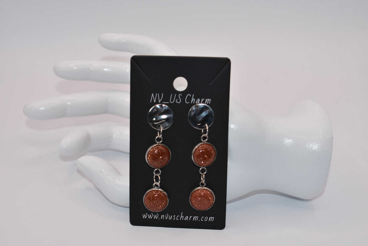 Add a touch of whimsy to any outfit with our Brown Collection earrings! These super comfortable and stylish earrings feature beautiful copper sparkling cabochon stones and hypoallergenic silver posts for sensitive ears. With a versatile neutral color, they'll easily complement any look. Earrings hang 2 inches from the ear for a perfect statement.