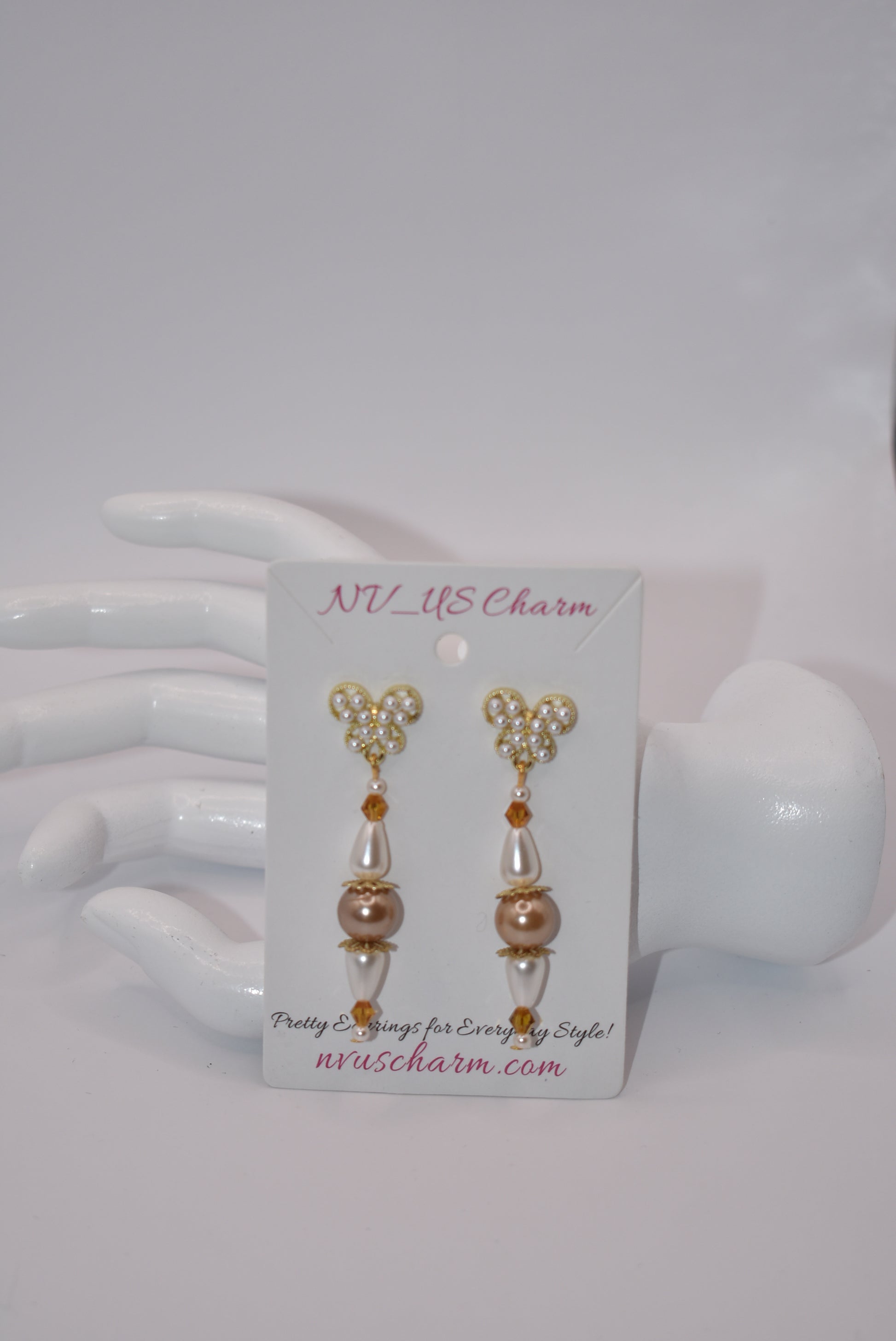 Add some whimsy to your wardrobe with our Brown Collection! These hypoallergenic earrings feature tiny pearl butterfly posts and a mix of pretty pearls and crystals hanging approximately 1 1/2 inches from your ear. Comfortable and stylish, these earrings are perfect for any occasion.